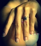 Awesome M Shaped Tattoo Design on Ring Finger 