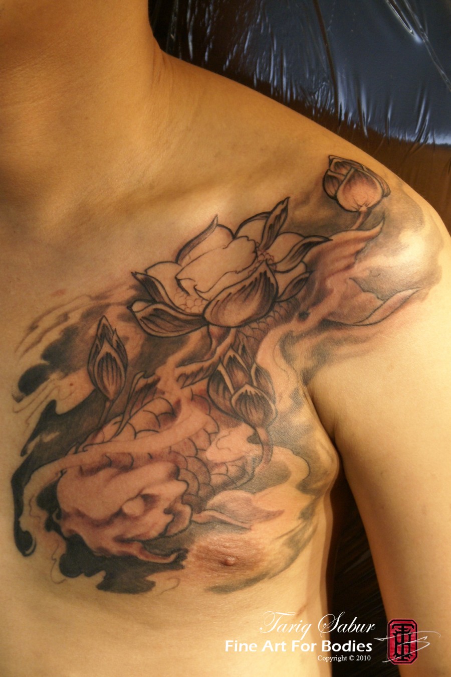 Beautiful Mythical Koi and Lotus Chest Tattoo Design For Men