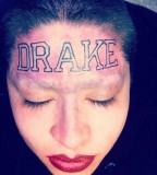 Bold Lettering Name Tattoo on Women Forehead