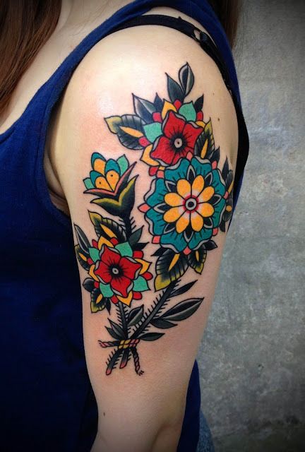 traditional style arm flower tattoo