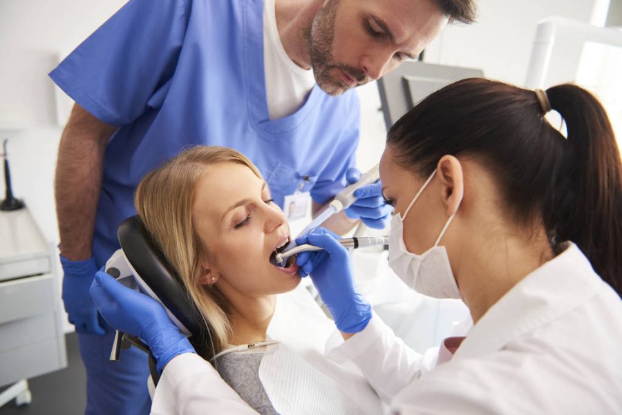 Young woman is getting treatment in dentist’s office