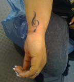 Small and Cute Treble Clef Musical Tattoo on Inner Wrist