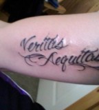 Beautiful Completed Swirly Veritas Aequitas Tattoo Design on Inner Upper Arm