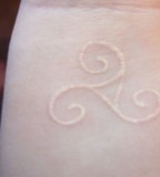Simple Symbol Tattoo with White Ink