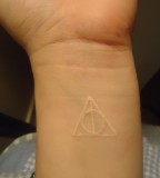 Simple Symbol White Ink Tattoo On Forearm